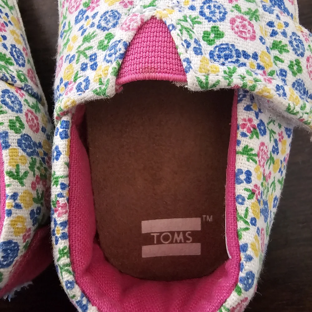 3 pairs of baby/girl shoes—soft, floral, and glittery—in various styles.